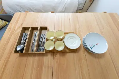 a tray with plates and utensils on a table at Minamishinagawa A-yokocho Base in Tokyo