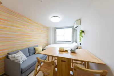 a living room with a couch and a table at Minamishinagawa A-yokocho Base in Tokyo