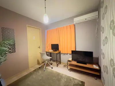 a room with a chair and a desk and a television at RelaxKoenjiHouse! 3LDK 4minSta Shinjuku7min Bright,Fun,Cozy! KidsFree Under6yrs in Tokyo