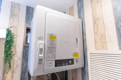 a microwave oven on the wall of a kitchen at RelaxKoenjiHouse! 3LDK 4minSta Shinjuku7min Bright,Fun,Cozy! KidsFree Under6yrs in Tokyo