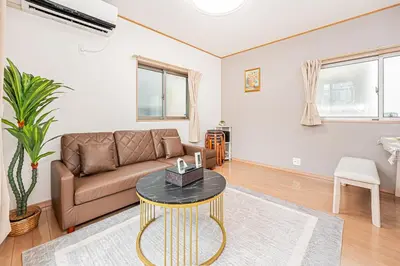 a living room with a couch and a table at Ohanachaya station 5-minute walk 4ldk house maxi 9people family friendly in Tokyo