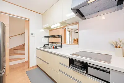 a kitchen with white cabinets and a sink at Ohanachaya station 5-minute walk 4ldk house maxi 9people family friendly in Tokyo