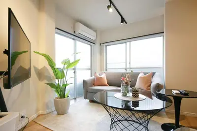 a living room with a couch and a table at 9STAY Shibuya Shinsen in Tokyo