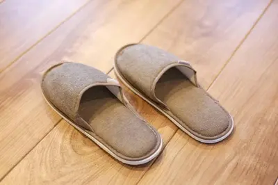 a pair of shoes sitting on a wooden floor at 9STAY Shibuya Shinsen in Tokyo
