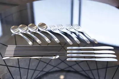 a group of forks and spoons on a rack at 9STAY Shibuya Shinsen in Tokyo