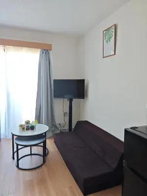 a living room with a couch and a table at \u30e1\u30ea\u30b9\u6c60\u888bEast 402 in Tokyo