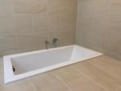 a white bath tub in a bathroom with tiles at Hotel Risveglio Akasaka in Tokyo