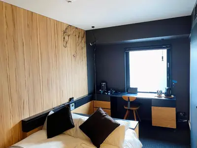 a bedroom with a bed and a desk and a window at Hotel Risveglio Akasaka in Tokyo