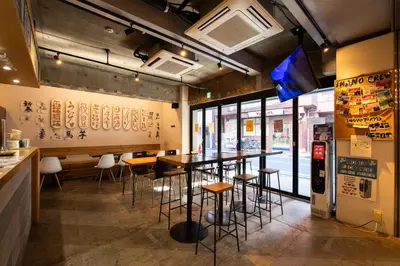 a restaurant with tables and chairs in a room at Imano Tokyo Hostel in Tokyo