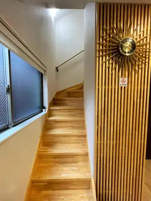 a hallway with a staircase with a wooden floor and a window at KAKURE Jujo 7min Ikebukuro 11min Shinjuku 16min Shibuya Walk to Jujo & Itabashi-Honcho ,Up to 5 Guests in Tokyo