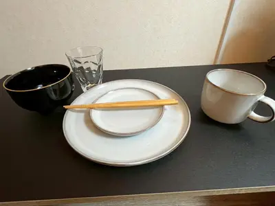 a pair of chopsticks on a plate next to a cup at A nostalgic Japanese atmosphere in Shibuya in Tokyo