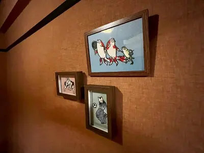 a wall with three pictures of chickens on it at A nostalgic Japanese atmosphere in Shibuya in Tokyo