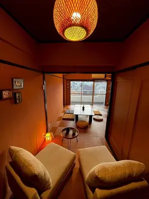 a small room with a table and chairs and a light at A nostalgic Japanese atmosphere in Shibuya in Tokyo