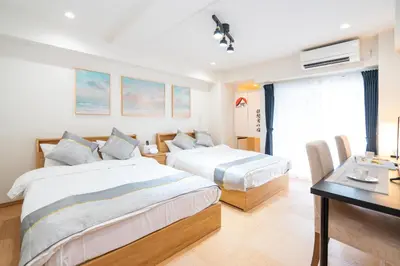a hotel room with two beds and a desk at Riverview APT, Asakusa-Skytree area, 4 min to Metro in Tokyo