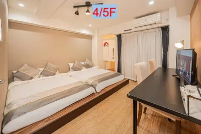 a bedroom with a large bed and a desk at Riverview APT, Asakusa-Skytree area, 4 min to Metro in Tokyo