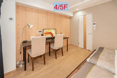 a room with a desk with chairs and a bed at Riverview APT, Asakusa-Skytree area, 4 min to Metro in Tokyo