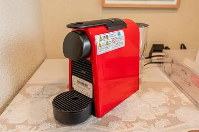 a red toaster sitting on top of a counter at Riverview APT, Asakusa-Skytree area, 4 min to Metro in Tokyo