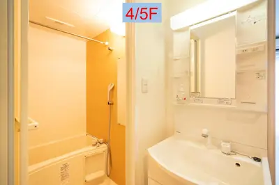a bathroom with a sink and a toilet and a mirror at Riverview APT, Asakusa-Skytree area, 4 min to Metro in Tokyo