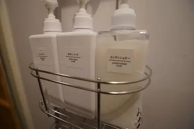 a rack with four bottles of milk in a refrigerator at tonema in Tokyo