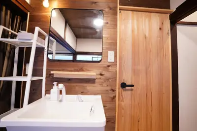 a bathroom with a white sink and a mirror at tonema in Tokyo