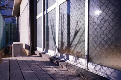 a shadow of a person on the side of a building at tonema in Tokyo