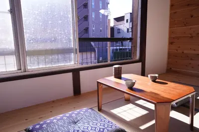 a room with a table and a large window at tonema in Tokyo