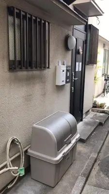 a trash can sitting outside of a house at Sweet House Sugamo 101 in Tokyo