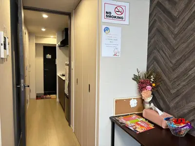 a hallway with a table and a no smoking sign on a wall at Yui SAYAKA-SAYAKA 701 Luxury Upper-Floor Stay Near Asakusa in Tokyo