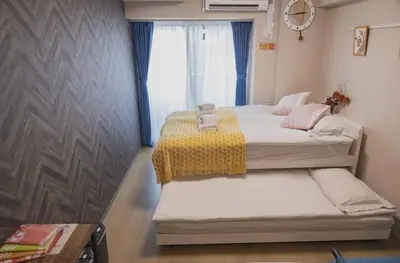 two beds in a small room with a window at Yui SAYAKA-SAYAKA 701 Luxury Upper-Floor Stay Near Asakusa in Tokyo