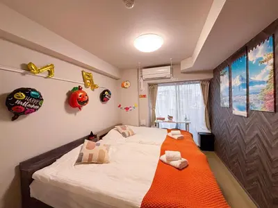 a bedroom with a bed with an orange blanket at Yui Asakusa-MIYABI 702 City-Center Luxury Stay-Walk to Asakusa in Tokyo