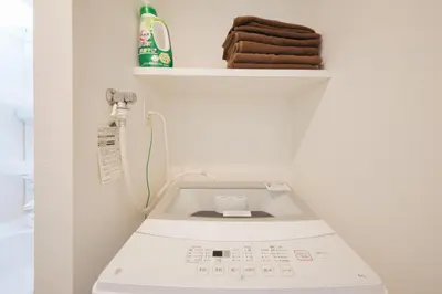 a washing machine in a bathroom with a shelf at \u30a2\u30ec\u30b9\u30b0\u30fc\u30c6\u65e9\u7a32\u7530 in Tokyo