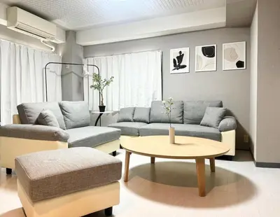 a living room with a couch and a table at Roppongi 3min Walk, Shinjuku 10min,Shibuya 15min, Tokyo Tower 58sqm for 6 in Tokyo