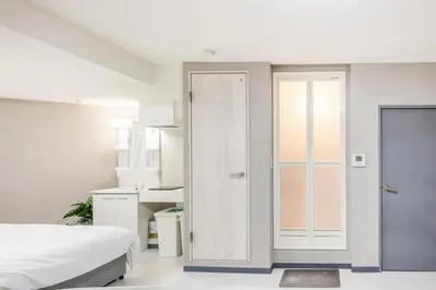 a bedroom with a bed and a sliding door at Roppongi 3min Walk, Shinjuku 10min,Shibuya 15min, Tokyo Tower 58sqm for 6 in Tokyo