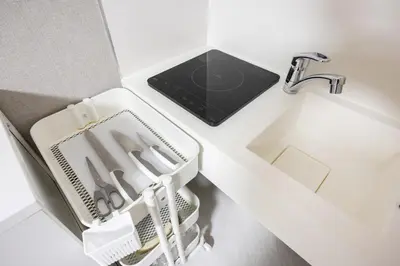 a kitchen counter with a sink and a dish drying rack at Roppongi 3min Walk, Shinjuku 10min,Shibuya 15min, Tokyo Tower 58sqm for 6 in Tokyo