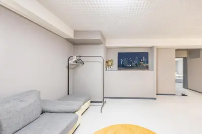 a living room with a couch and a refrigerator at Roppongi 3min Walk, Shinjuku 10min,Shibuya 15min, Tokyo Tower 58sqm for 6 in Tokyo