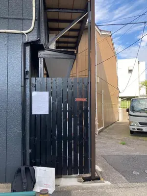 a black gate in front of a building at Realization INN Horikiri in Tokyo