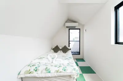 a bedroom with a bed and a green floor at New decorative 6ppl 3-Story House 5-mins walk Sta in Tokyo
