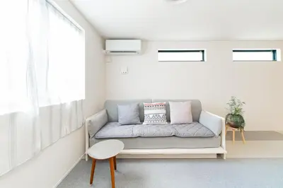 a living room with a couch and a window at New decorative 6ppl 3-Story House 5-mins walk Sta in Tokyo