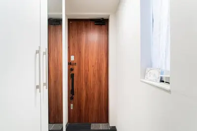 a hallway with a wooden door in a room at New decorative 6ppl 3-Story House 5-mins walk Sta in Tokyo