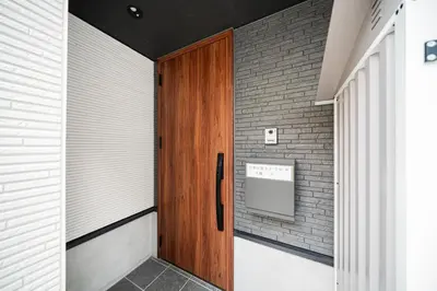 a wooden door in a room with a brick wall at New decorative 6ppl 3-Story House 5-mins walk Sta in Tokyo