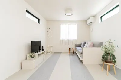 a white living room with a couch and a tv at New decorative 6ppl 3-Story House 5-mins walk Sta in Tokyo
