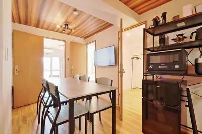 a dining room and living room with a table and chairs at V Close to Shinjuku Kabukicho Korean Town FrWIFI B in Tokyo