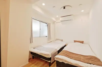 two beds in a room with a window at V Close to Shinjuku Kabukicho Korean Town FrWIFI B in Tokyo