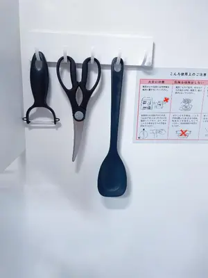 a pair of scissors and a thermometer hanging on a wall at Mie's House Skytree 美英軒 in Tokyo