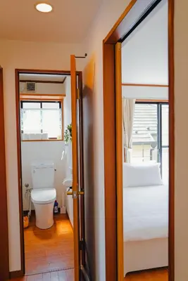 a bathroom with a toilet and a window at Akira Hiro House in Tokyo