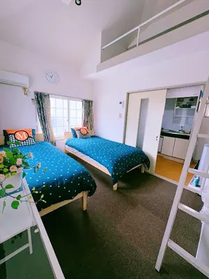 a bedroom with two beds and a bunk bed at M-house in Tokyo