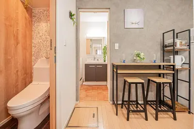 a bathroom with a toilet and a counter with stools at 101 6-min walk from Higashi-Jūjō Station Cozy 1-Bedroom Apartment Direct Access to Akihabara & Ueno in Tokyo