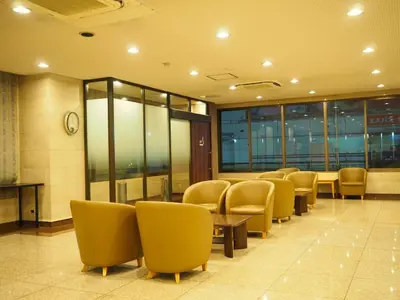 a waiting room with chairs and tables and a clock at Smile Hotel Tokyo Shinkoiwa - Vacation STAY 82158v in Tokyo