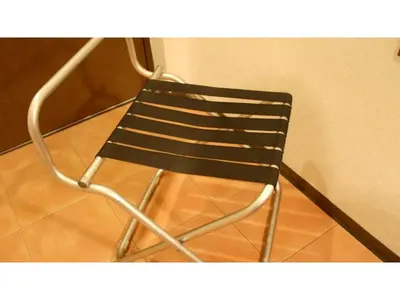 a black chair sitting on top of a wooden floor at Smile Hotel Tokyo Shinkoiwa - Vacation STAY 82180v in Tokyo