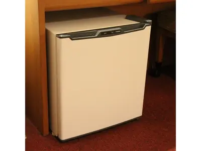 a small white refrigerator sitting under a desk at Smile Hotel Tokyo Shinkoiwa - Vacation STAY 82180v in Tokyo